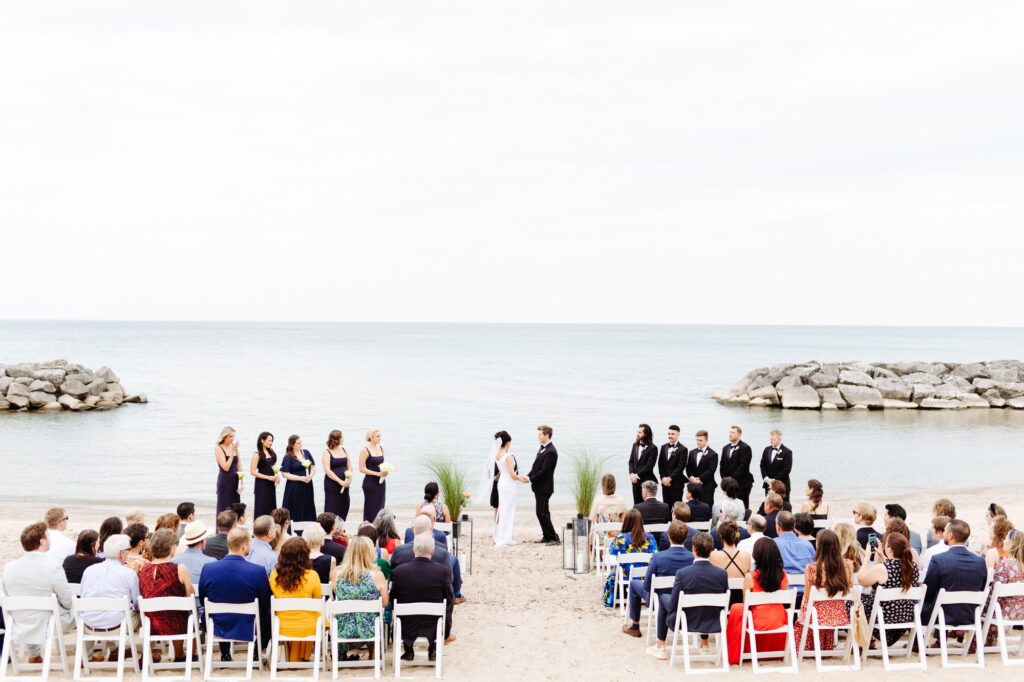 Wedding ceremony on the beach with water views at Rosewood Beach in Highland Park