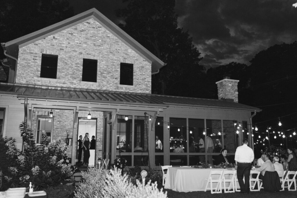 Reception and dinner with guests in front of beautiful house at night