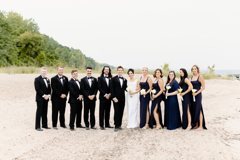 Bridal party in a line on the beach at Rosewood Beach in Highland Park