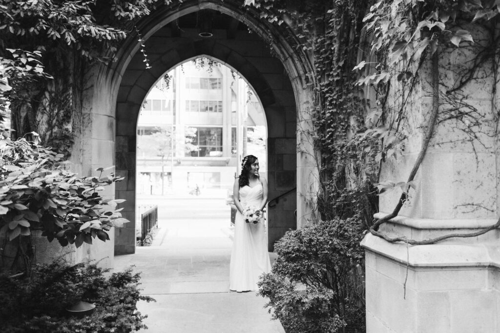 Bride standing in beautiful stone archway in Chicago