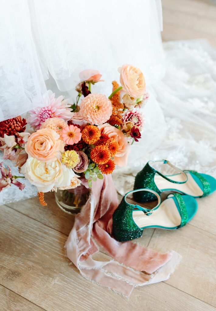 Brides shoes, bouquet and bottom of wedding dress used in a detail photo