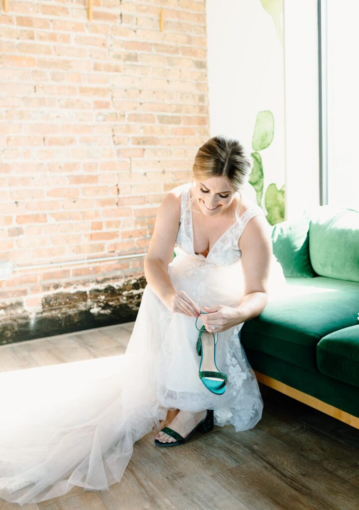 Bride smiling and putting on her shoes