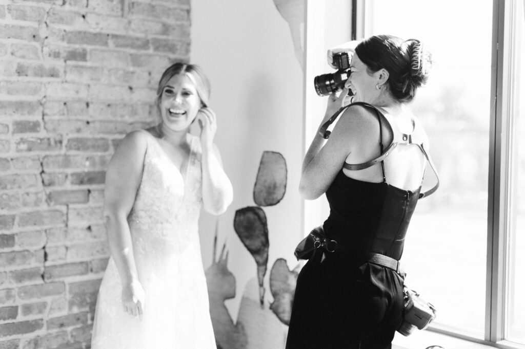 behind the scenes photo of Melissa Stuckey photographing the bride with her earrings