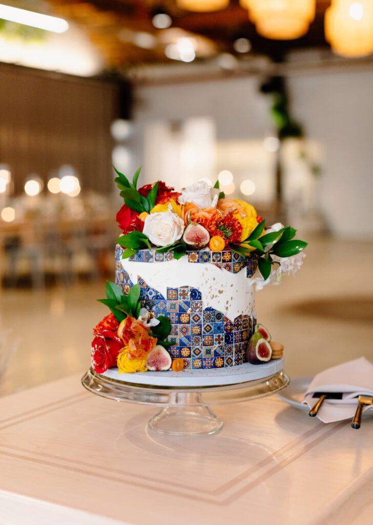 Wedding cake with frosting details and tiles and flowers