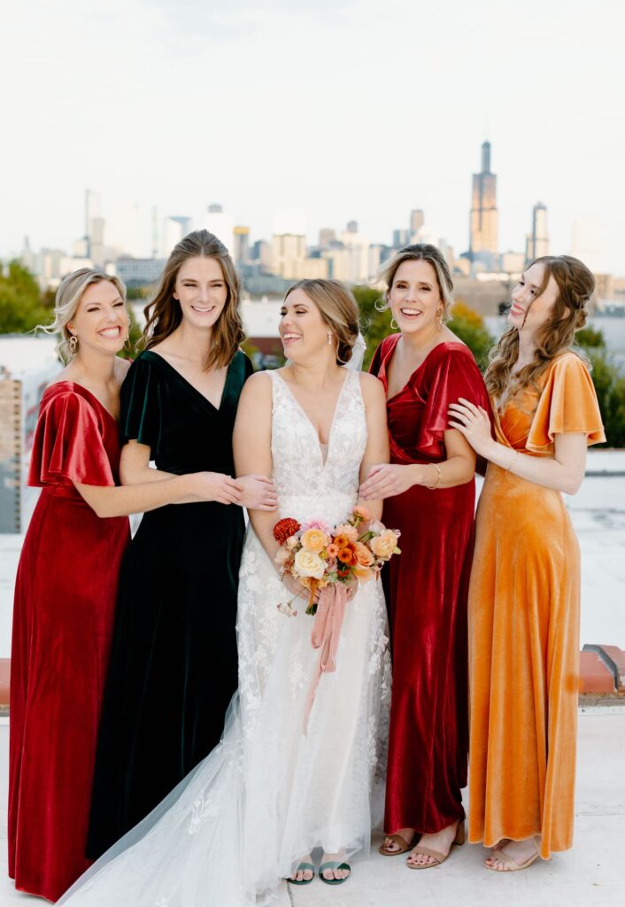 Bride and Bridesmaids laughing at each other on the roof at the Walden