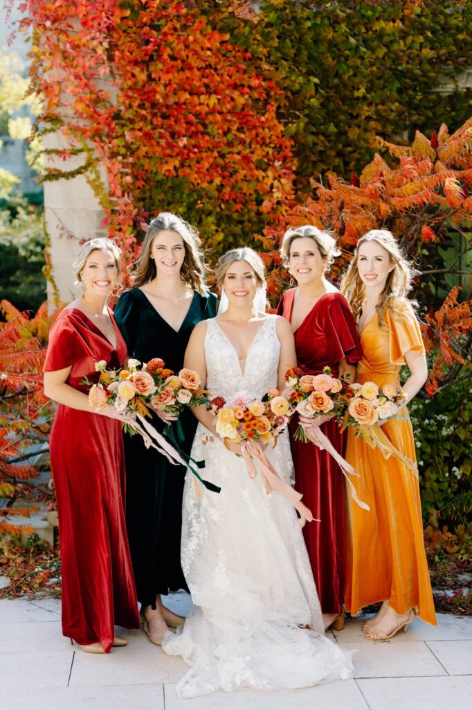 Bride and Bridesmaids holding bouquet looking at the camera