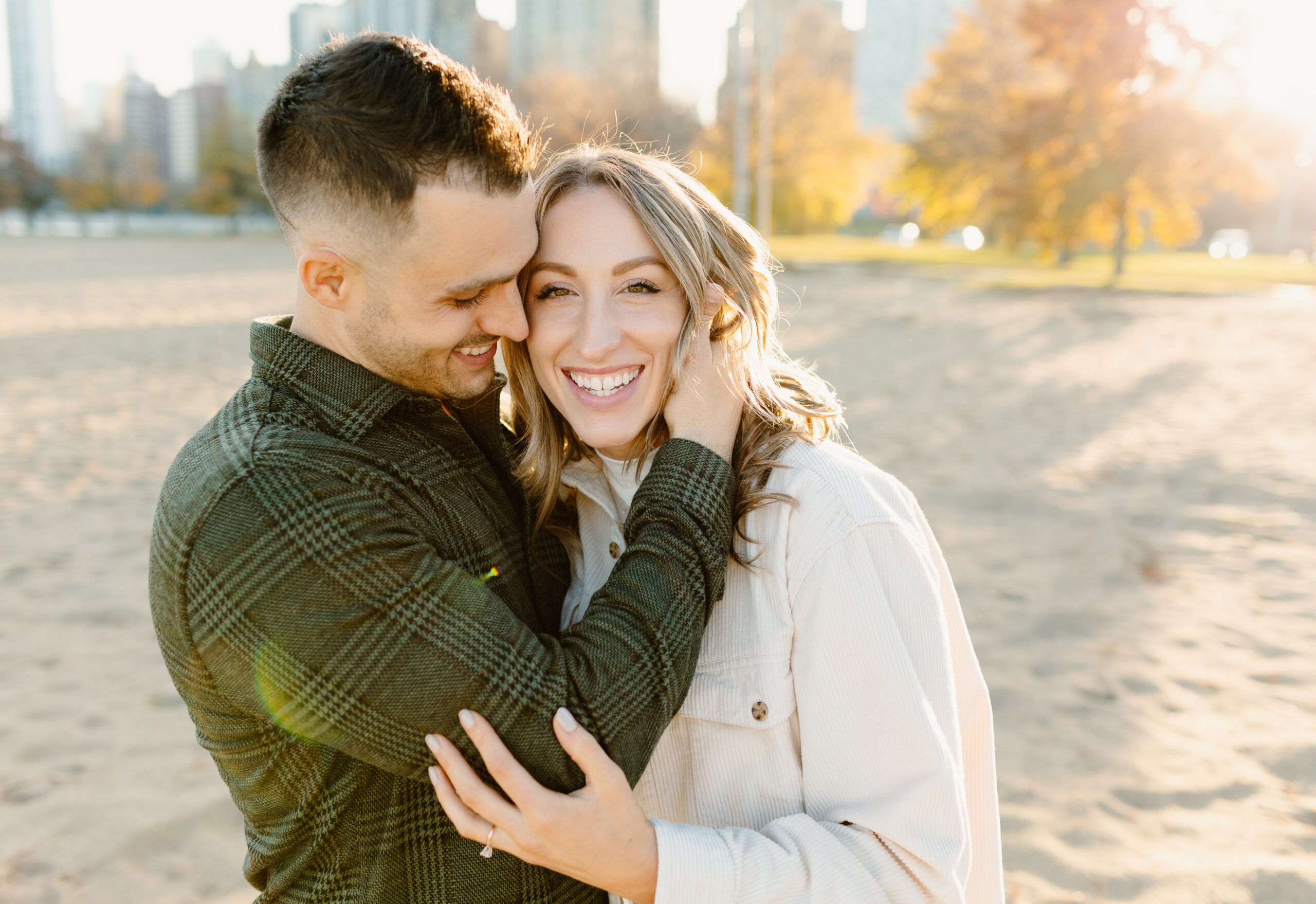 a couple snuggled together on north avenue beach in Chicago