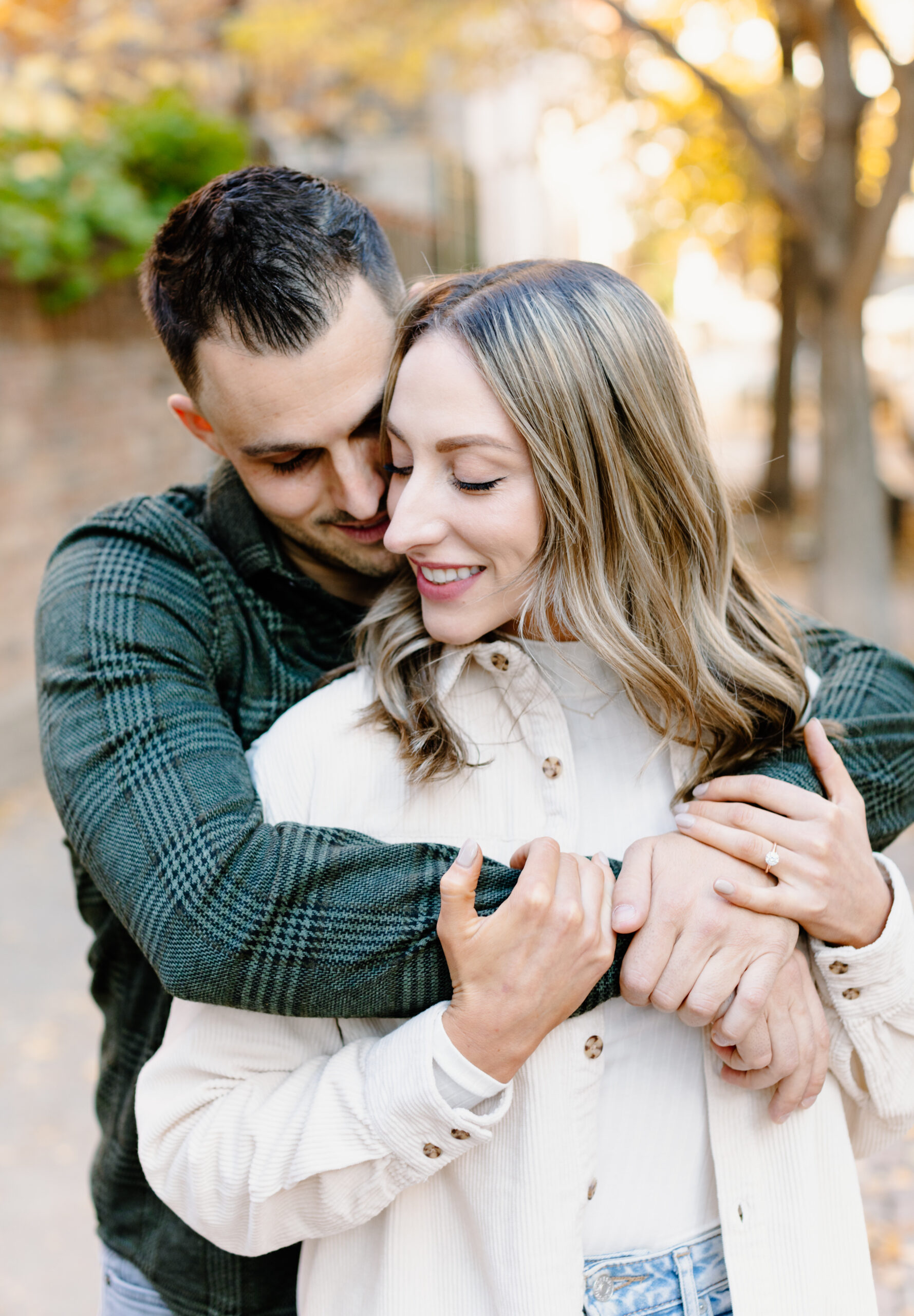 A couple snuggled up in Old town Chicago during their Engagement session in Chicago
