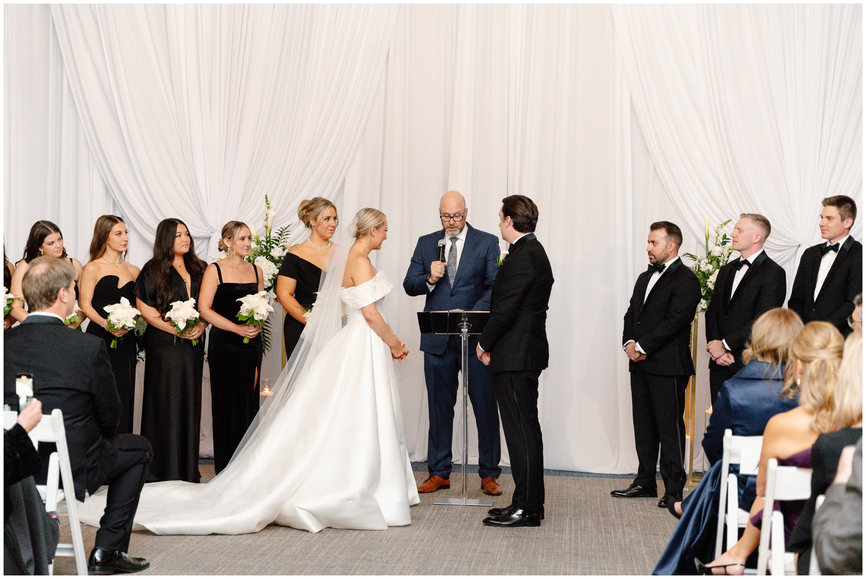 Newlyweds stand at the altar with their officiant and wedding party during their Hyatt Lodge Oak Brook Wedding ceremony