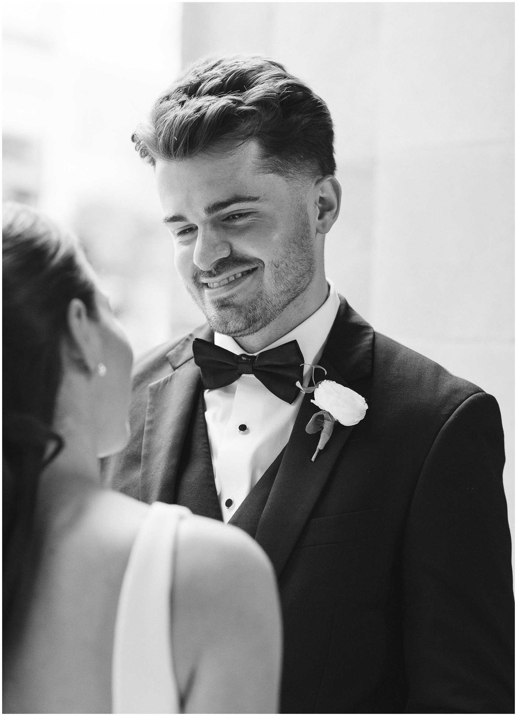 A groom smiles down to his bride as they hold hands during their the arbory chicago wedding