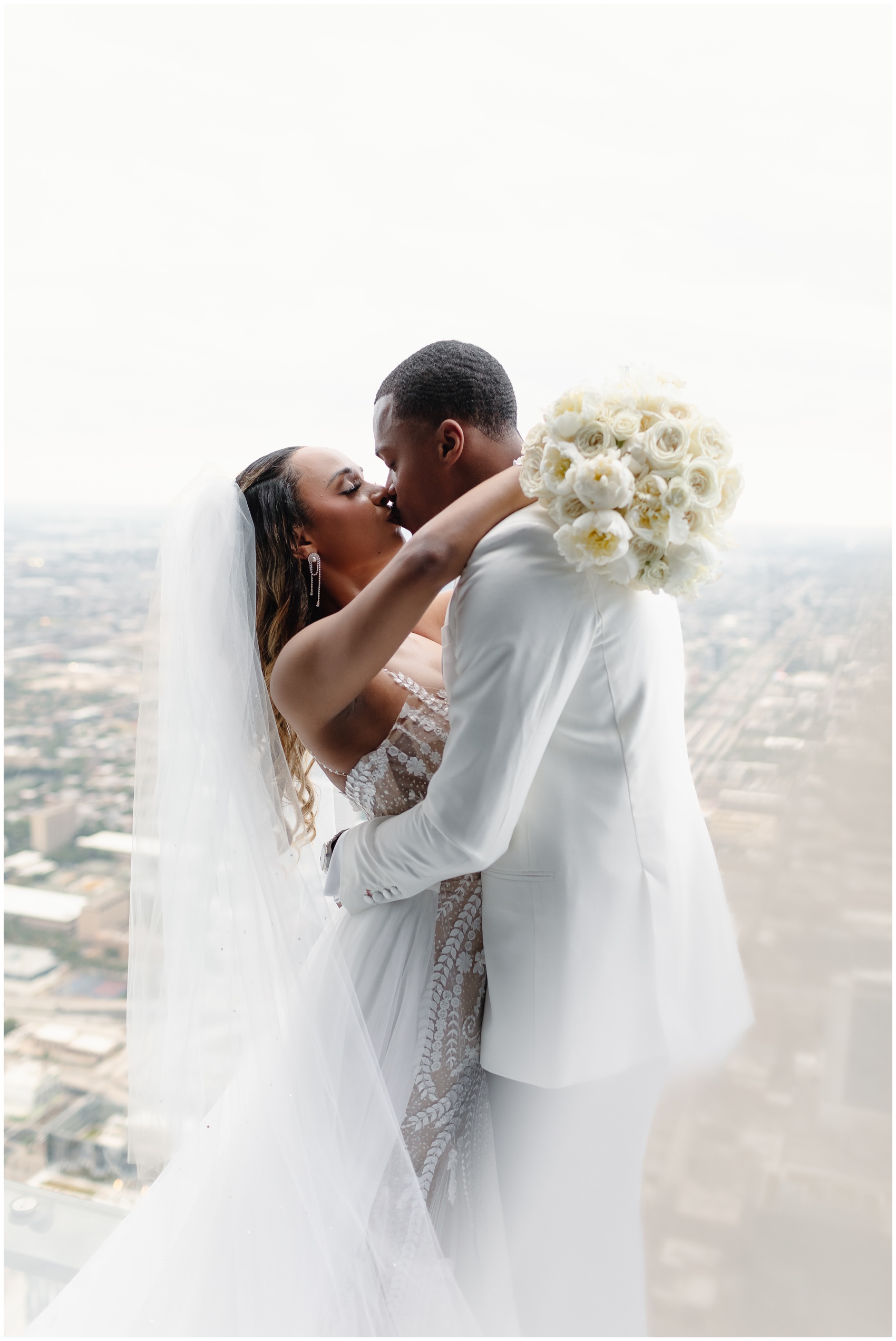 Newlyweds kiss over the Chicago skyline thanks to help from Chicago Wedding Planners