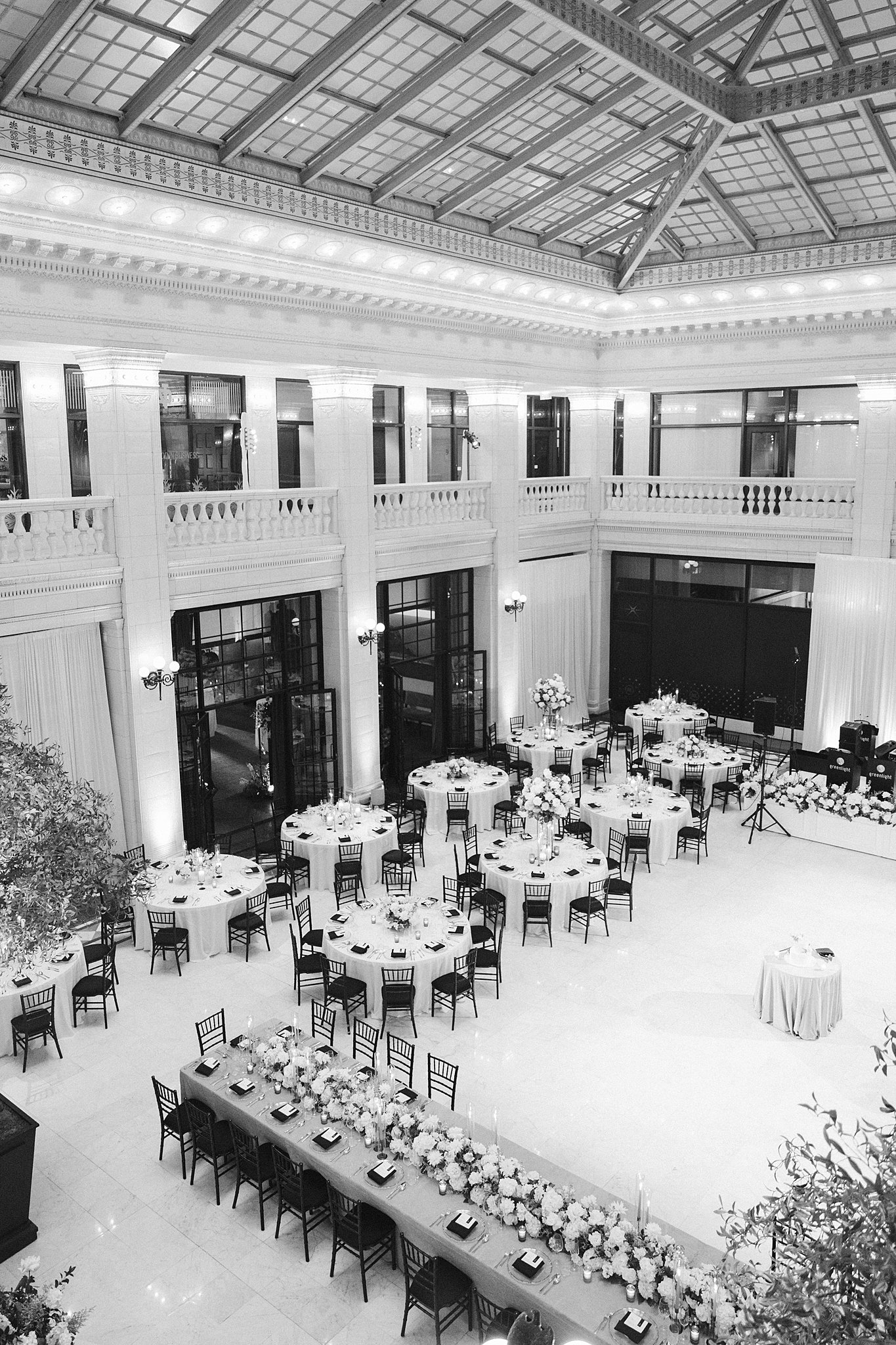 A black and white image of a wedding reception from a balcony