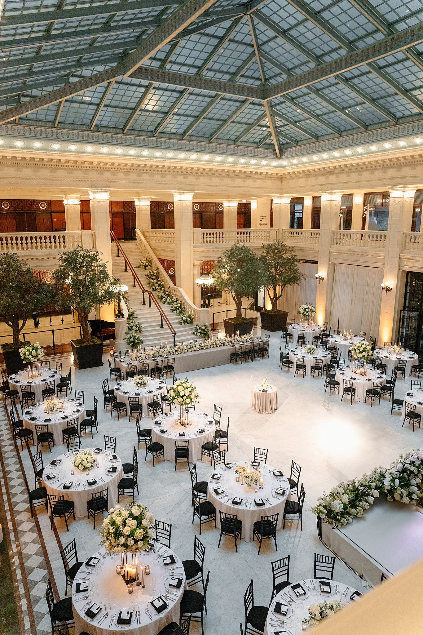 A look form the balcony of one of the Downtown Chicago Wedding Venues set up with round tables lining a dance floor and stage